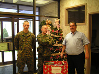 Three Men Standing by Box of Toys for Toys For Tots